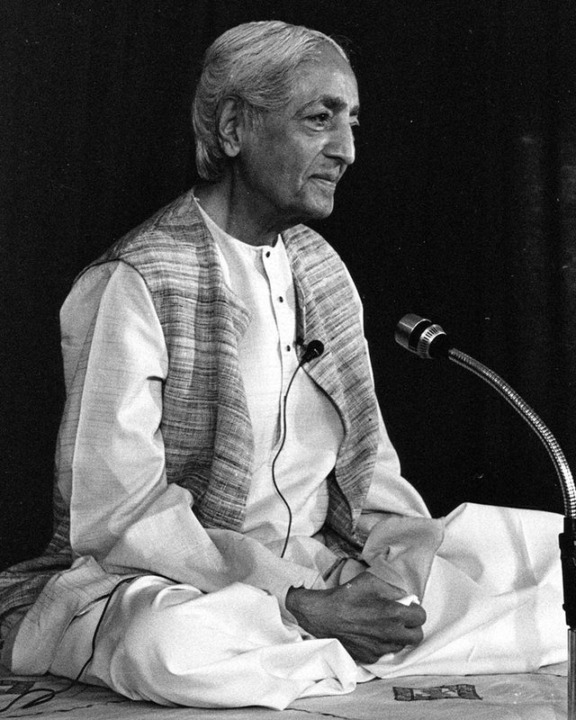 J. Krishnamurti seated, giving a talk